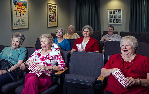 An older man is sitting at a table with a plate of food in front of him. AI generated content