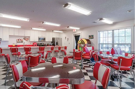 A restaurant with a red and black checkered floor and a red booth. AI generated content