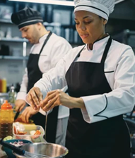 Two chefs in a kitchen preparing food. AI generated content