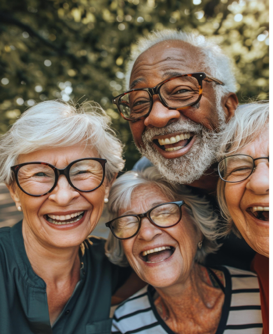 Four people are posing for a picture, all wearing glasses. They are smiling and seem to be enjoying the moment. AI generated content